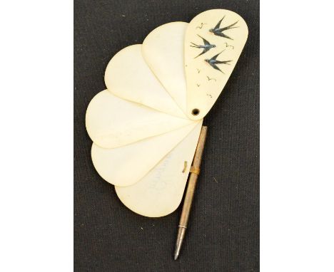 A 1930s folding fan, the simulated tortoiseshell guards pivoting to form a handle, plain sticks edged with trimmed exotic spo