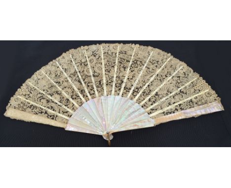 A late 19th century folding fan with mother of pearl guards and sticks with pierced bone slips, with paste rivet and metal lo