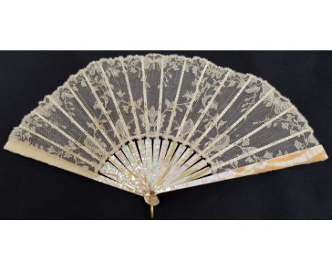 An early 19th century folding fan with plain mother of pearl guards and sticks with pierced bone slips and gilt metal loop, w