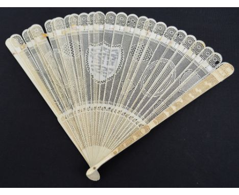 A 19th century Canton export brisé fan, the ivory guards finely carved with a floral motif and a scene of buildings at the en