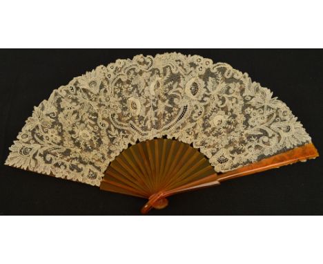 An early 20th century English folding fan with gilt heightened ivory coloured painted wood guards and sticks, with a metal lo