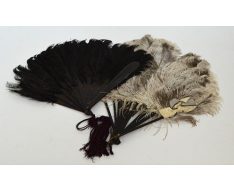 An early 20th century feather folding fan with faux tortoiseshell guards and sticks of plain form, with loop suspending a pur