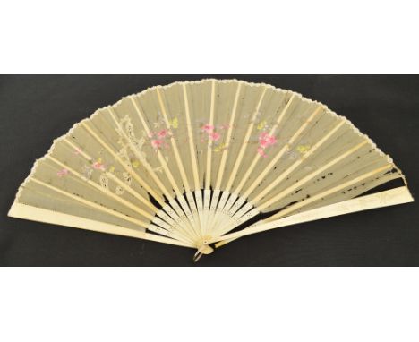 An Edwardian folding fan with carved and pierced bone guards and sticks with bone edged rivet and a loop, the silk leaf paint