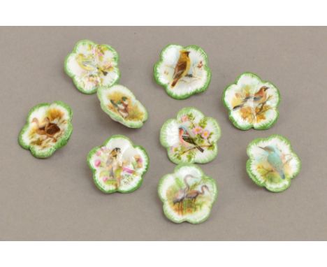 A set of ten ceramic buttons of lobed flower form, each decorated with a different bird including ducks, goldfinch, swans, ki
