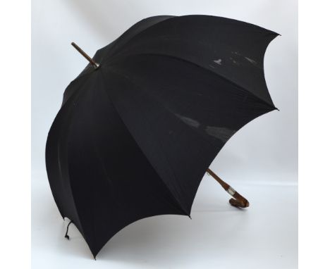 A late 19th century black umbrella labelled "Paragon, S Fox & Co Ltd", with gnarled cherry wood handle and a hallmarked silve