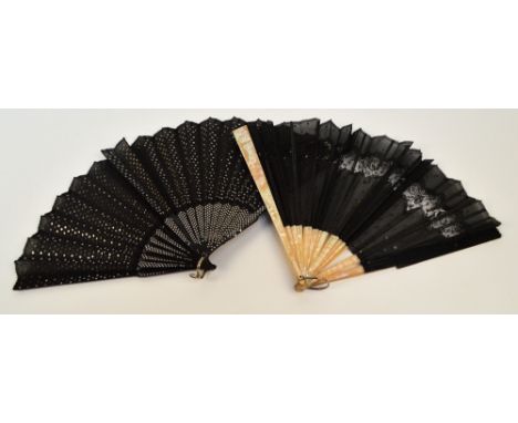 A 1930s folding dance fan, the black guards and sticks studded with metallic dots, with mother of pearl edged rivet and shape