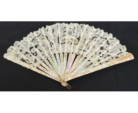 An early 20th century Continental folding lace fan, with plain mother of pearl guards and sticks, with pierced bone slips and