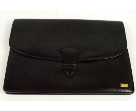 CELINE; a black leather clutch bag enclosing various compartments and a zipped section, 28 x 19cm.