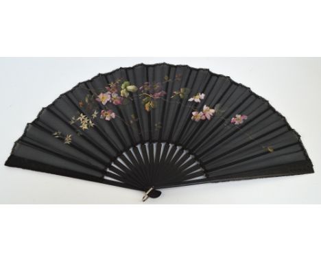 An early 20th century large folding fan with ebonised carved guards and matching sticks with black edged rivet and steel loop