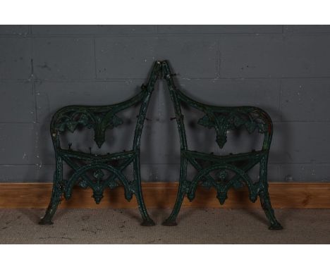 Pair of cast iron bench ends, painted in green, 83cm high