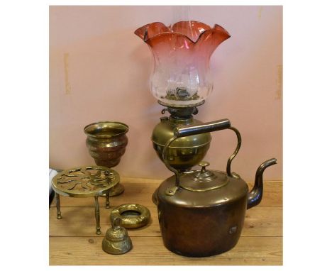 Assorted metal work to include; brass paraffin/oil lamp with cranberry shade, oval copper kettle, brass trivet, Indian Benare