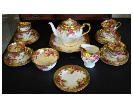 Royal Chelsea 'Golden Rose' pattern tea service comprising: six cups, five saucers and five plates, cake/bread plate, teapot,