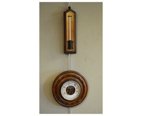 Early 20th Century walnut-cased aneroid barometer of circular form, together with an 'Improved House Thermometer' with oak ba