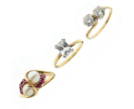 Three 9ct gold dress rings comprising: a ruby and pearl crossover design ring and two CZ rings, 6.9g gross approx (3)  