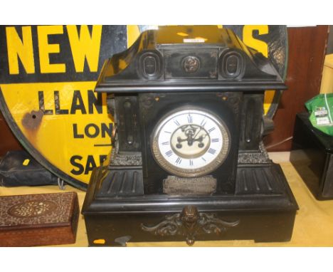 A LARGE BLACK SLATE MANTEL CLOCK WITH INSCRIPTION H 46 CM, W 48 CM, D 18 CM APPROX.