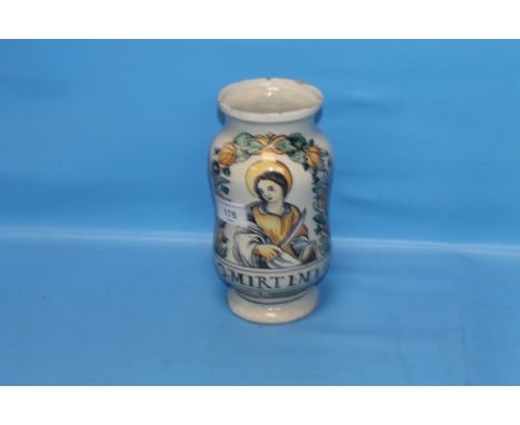 A CONTINENTAL ALBARELLO TYPE GLAZED PHARMACY JAR, decorated with a saint and the legend "O Mirtini" height 19 cm