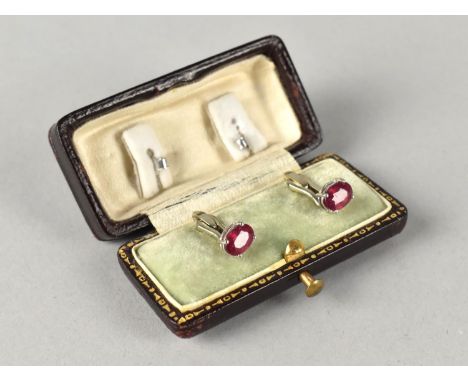 A Pair of Ruby Stud Earrings, Oval Cut Stones Measuring 7.1mm by 4.9mm, Four White Metal Claws to Unmarked Posts, Butterfly B