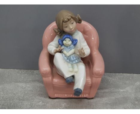 Nao by Lladro figure girl playing with doll on armchair