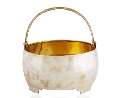 A FABERGE SILVER SUGAR BASKET WITH SWING HANDLEwith swing handle, atop four square feet, the interior gilt, marked with 84 st