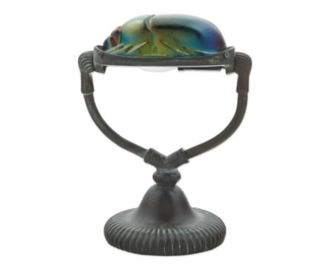 MANNER OF TIFFANY STUDIOS, “SCARAB” TABLE LAMPthe shade formed from a green iridescent glass a scarab beetle supported by a p