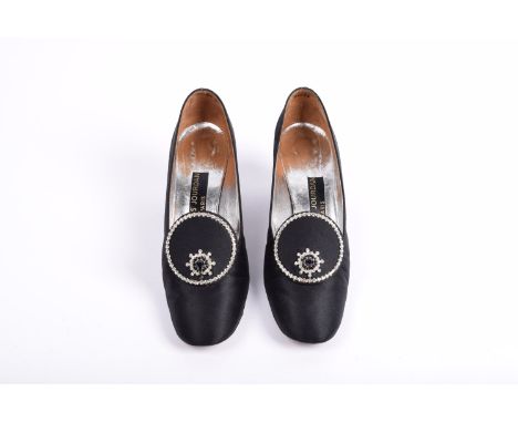 A pair of vintage Charles Jourdan court shoes , black satin finish, rounded toes, circular motif embellished with faux jewel 