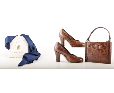 A Nina Ricci silk scarf in French navy with monogrammed 'Nina Ricci' print . Also a crocodile skin clutch bag with button cla