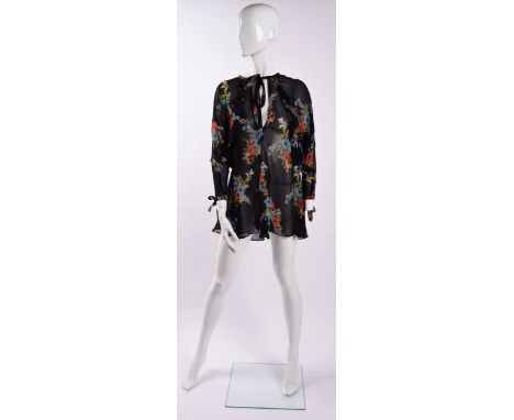 A vintage Ossie Clark floral printed blouse , batwing sleeves with bow tie fastenings to ends, frill detailing extending from