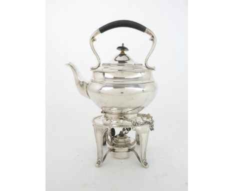 AN EDWARDIAN SILVER SPIRIT KETTLE AND BURNER&nbsp; the oval shaped kettle with ebonised scrolling handle and a gadrooned rim,