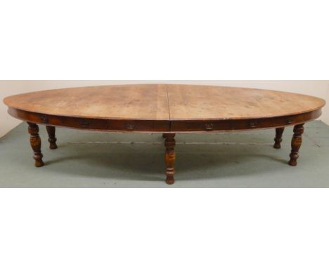 A LATE VICTORIAN OAK OVAL LIBARARY TABLEwith moulded oval top with six drawers to either side on six turned supports, 77cm hi