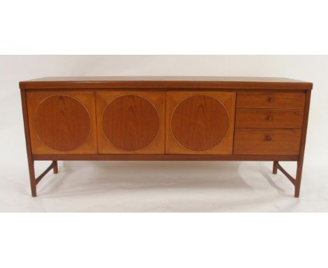 A MID 20TH CENTURY TEAK NATHAN CIRCLES SIDEBOARDwith two central cabinet doors flanked by single fall front cabinet to left a