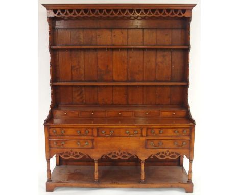 A 20TH CENTURY STAINED OAK WELSH STYLE DRESSERwith corniced plate rack top above five short drawers above three over two draw
