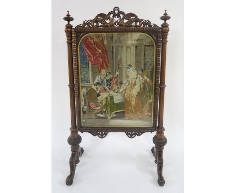 A VICTORIAN MAHOGANY AND ROSEWOOD FRAMED TAPESTRY FIRESCREEN with top rail carved in the form of two dragons above tapestry p