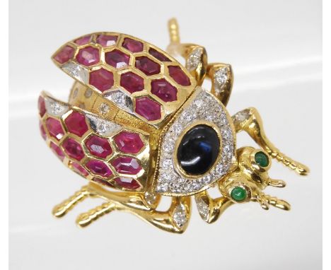 A RUBY, SAPPHIRE, & DIAMOND BEETLE BROOCH with emerald eyes. With articulated legs, head and wing casings, set throughout in 