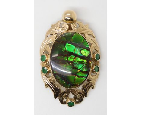 A YELLOW METAL AMMOLITE AND EMERALD PENDANT signed by goldsmith C. Noir, inscribed 14k. Set with an ammolite gemstone dimensi