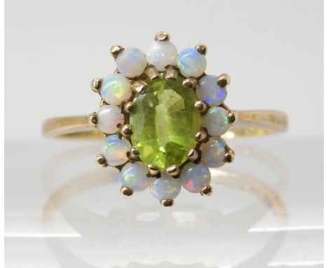 A 9CT GOLD PERIDOT AND OPAL CLUSTER RING the central peridot is approx 6.7mm x 5.3mm, surrounded with nice bright colourful o