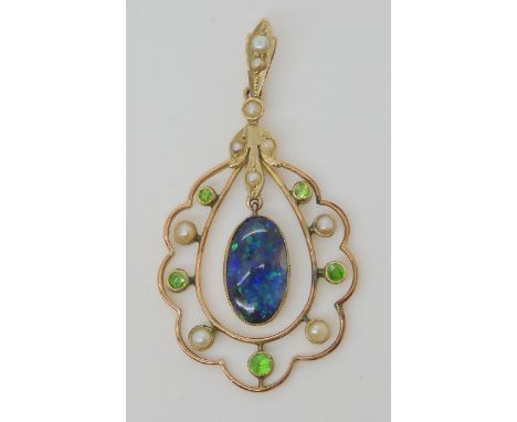 A BLACK OPAL EDWARDIAN PENDANT set with demantoid garnets and split pearls, the solid piece of black opal is 12mm x 7.5mm x 1