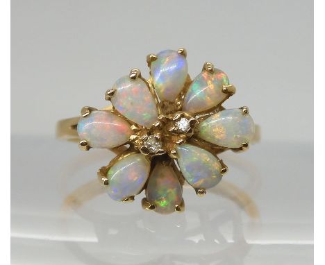 A RETRO 14K GOLD OPAL CLUSTER RING set with two diamond accents to the centre, span approx 13.4mm x 14.2mm, finger size L1/2,