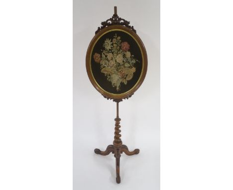 A VICTORIAN WALNUT TAPESTRY POLE SCREEN with oval tapestry panel supported on barley twist tripod base, 169cm high x 57cm wid