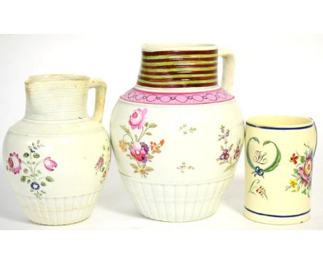 A Creamware small mug, circa 1780, of cylindrical form painted with initials and a cartouche and with flower sprays, 5.5cm hi