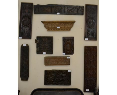 < An oak cupboard door, dated 1661, carved with a tulip and initialled RJ 1661, 24cm by 22.5cm; a walnut panel carved with an
