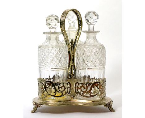 A Victorian silver plated decanter stand with strap handle on trefoil base with pierced scrollwork on cartouche feet, 32cm hi