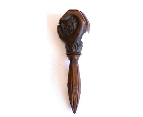 < A treen nut cracker, 19th century, as a hand holding a nut, 18cm