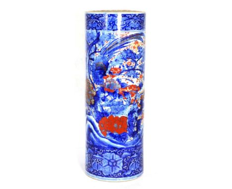 A Japanese porcelain stick stand, circa 1900, of cylindrical form, painted in red and underglaze blue with foliage within fol