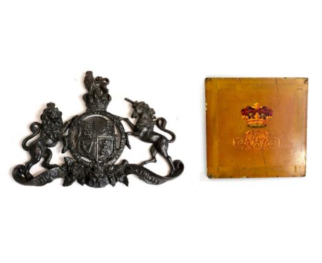 A cast iron plaque, with the arms of Queen Victoria, 29cm wide; and a small coach panel, painted with a Marquess's coronet ov