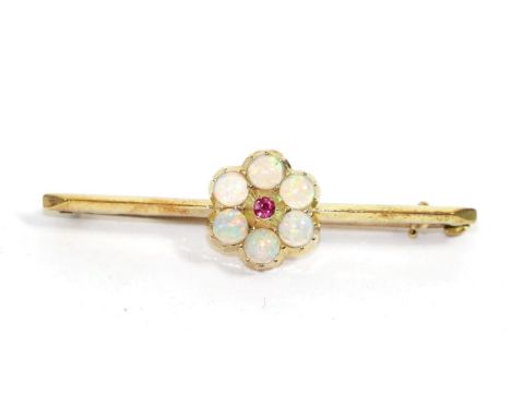 An opal and ruby bar brooch, a round cut ruby within a border of round cut opals in collet settings, to a knife edge bar, mea