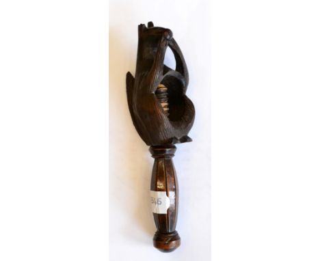 < A treen nut cracker, 19th century, modelled as a squirrel eating a nut, 21cm