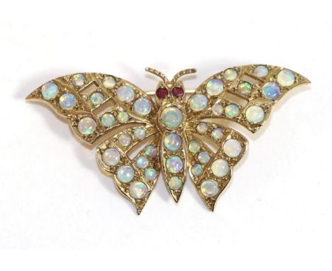 A 9 carat gold opal butterfly brooch, with ruby set eyes and wings and body set throughout with opals, measures 2cm by 4cm  T