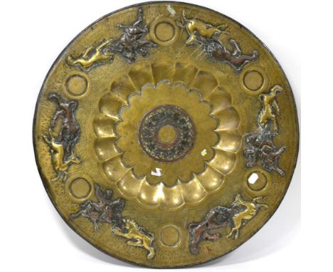 A Persian brass table top, late 19th century, of circular form, depicting horsemen hunting various wild animals, 76cm diamete