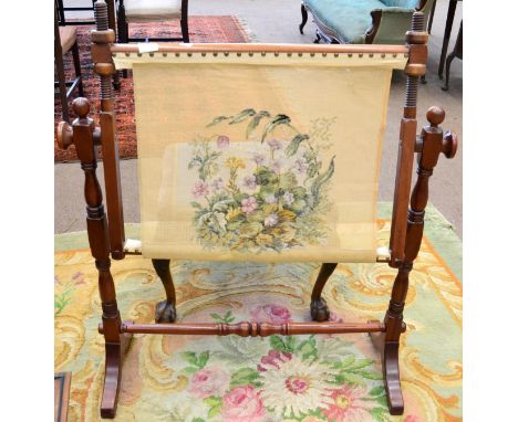 A 20th century mahogany tapestry frame on trestle support, 97cm wide, with a partially complete woolwork panel