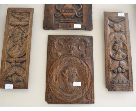 < A carved oak panel, probably Flemish, 16th century, with a fluted vase over a roundel with a bust portrait of a lady, 35.5c